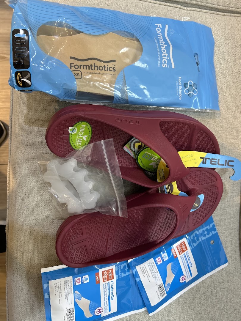 A collection of specialized foot care products, including orthotics, comfort sandals, and toe alignment tools.
