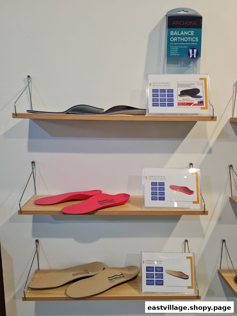 Various orthopedic insoles and foot care products are displayed on wooden shelves in a retail store.
