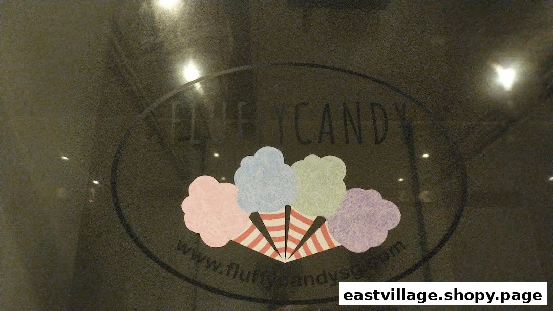 The Fluffy Candy shop logo featuring colorful cotton candy designs on a glass entrance.