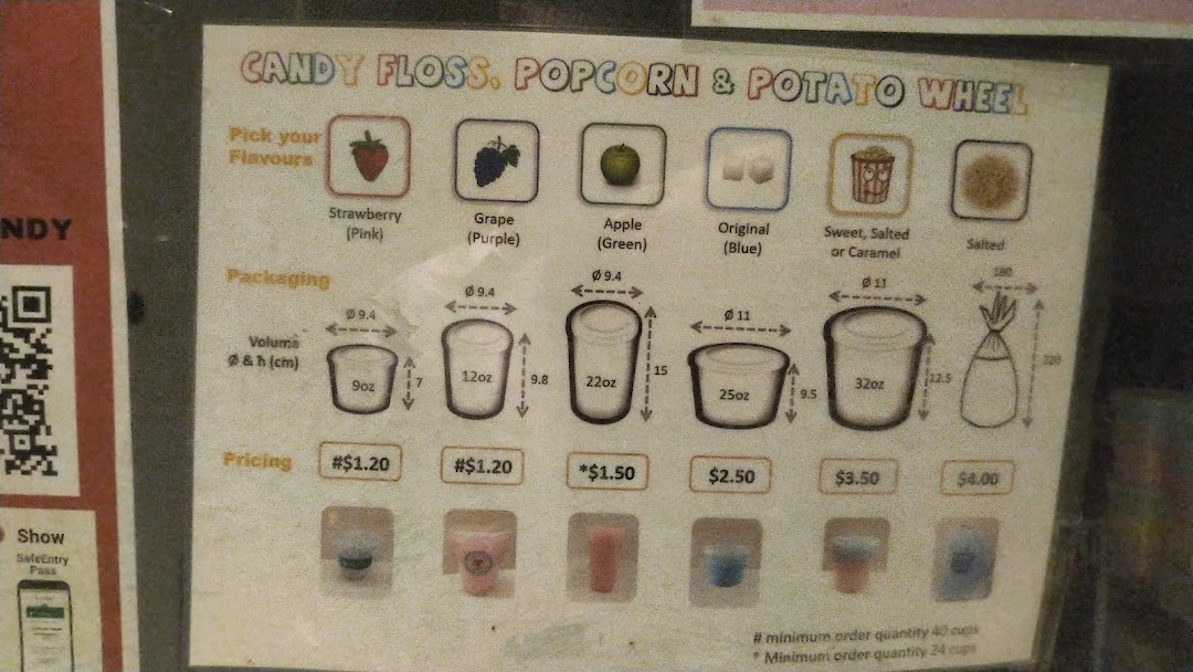 A menu board displaying prices and options for candy floss, popcorn, and potato wheel snacks.
