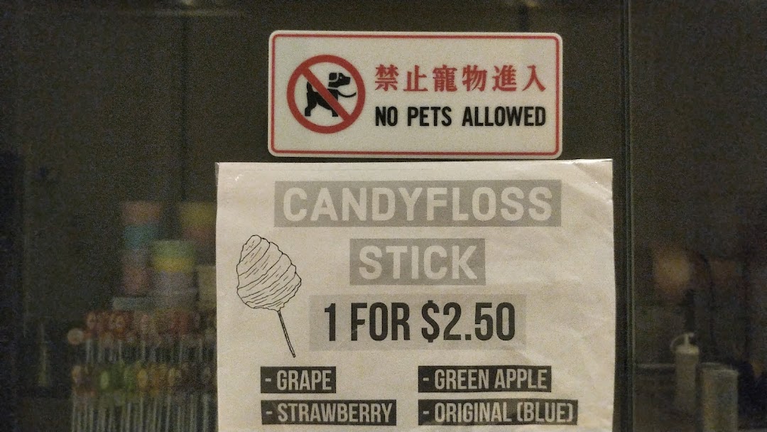 A sign displaying candyfloss stick flavors and pricing at Fluffy Candy.