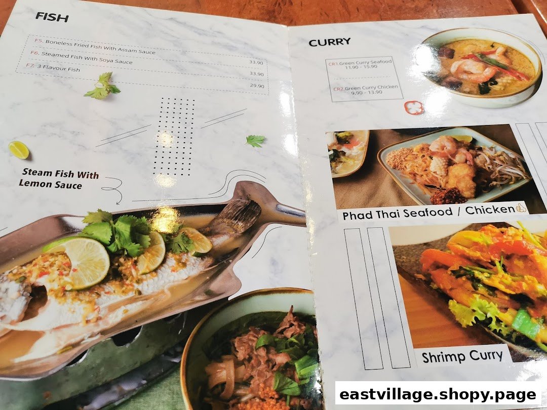 A close-up view of GreaThai's menu, showcasing various Thai fish, curry, and noodle dishes with prices.