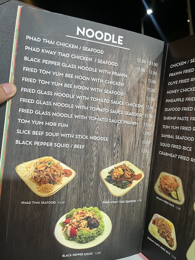 A close-up view of a Thai restaurant menu featuring noodle dishes and prices.