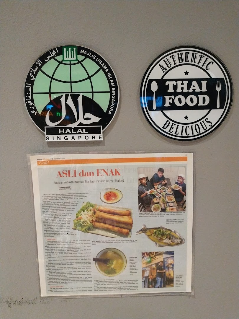 Two circular signs for Halal Singapore and Authentic Thai Food, alongside a newspaper article about the restaurant.