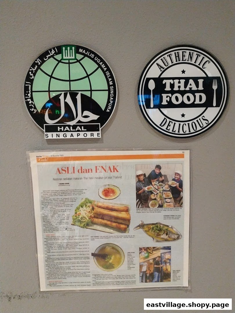 Two circular signs for Halal Singapore and Authentic Thai Food, alongside a newspaper article about the restaurant.