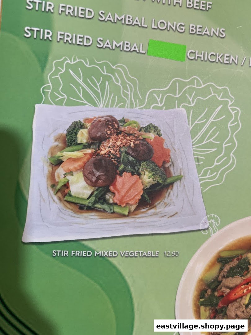 Close-up of GreaThai's menu featuring a vibrant stir-fried mixed vegetable dish and other Thai specialties.