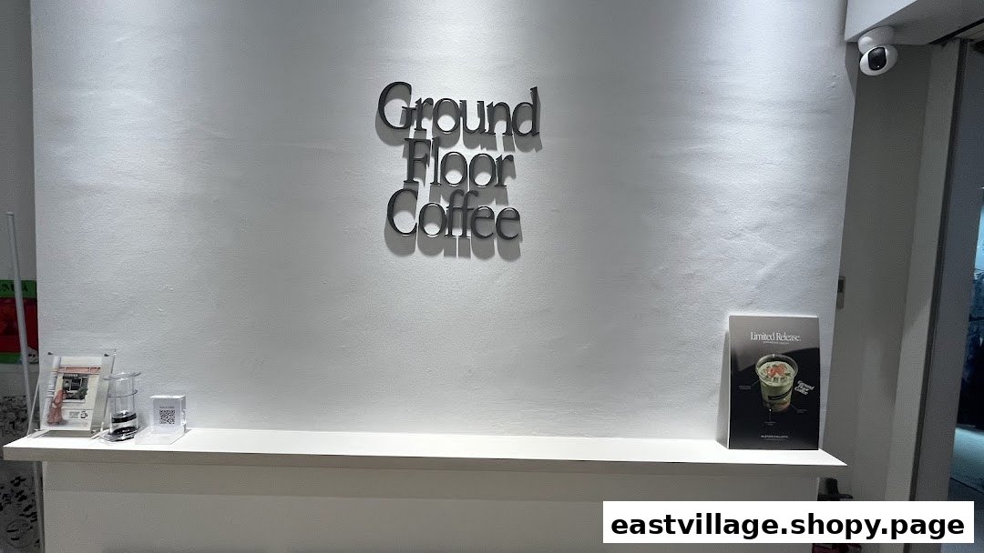 Interior view of Ground Floor Coffee featuring its prominent wall-mounted logo and a clean counter.