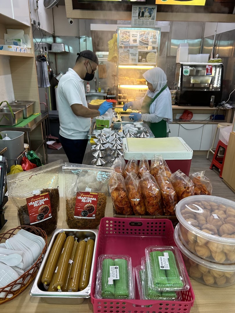 Staff prepare traditional snacks while a variety of packaged treats are displayed for sale.