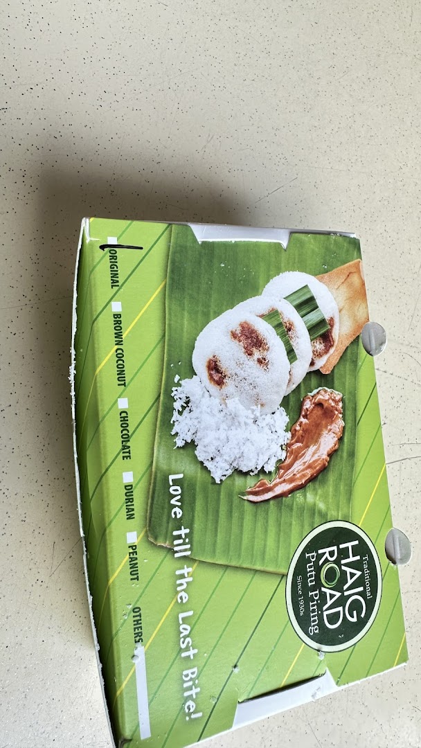 A box of Haig Road Putu Piring showcasing traditional rice cakes and available flavors.