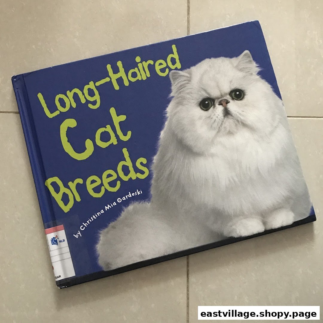 A book titled 'Long-Haired Cat Breeds' featuring a fluffy white cat on a blue cover.