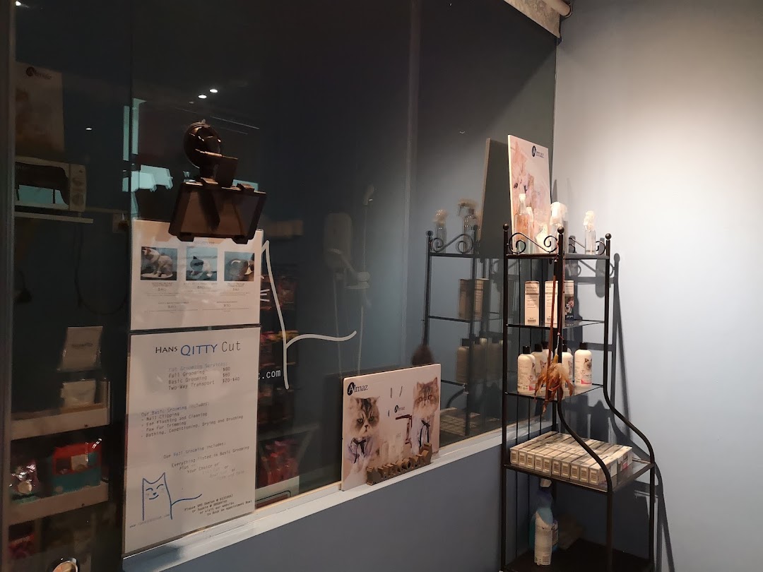 Interior view of Hans Qitty Cut, showcasing pet grooming services price list and product display.