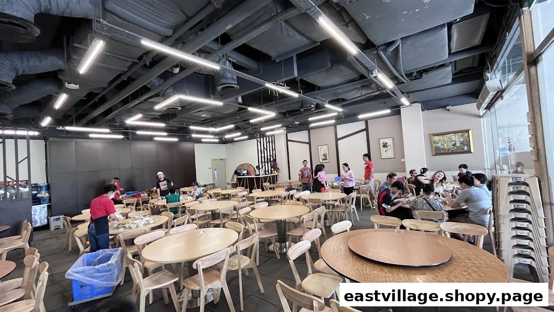 A spacious interior view of Hong Kong Street Family Restaurant, showing diners enjoying meals and staff attending tables.