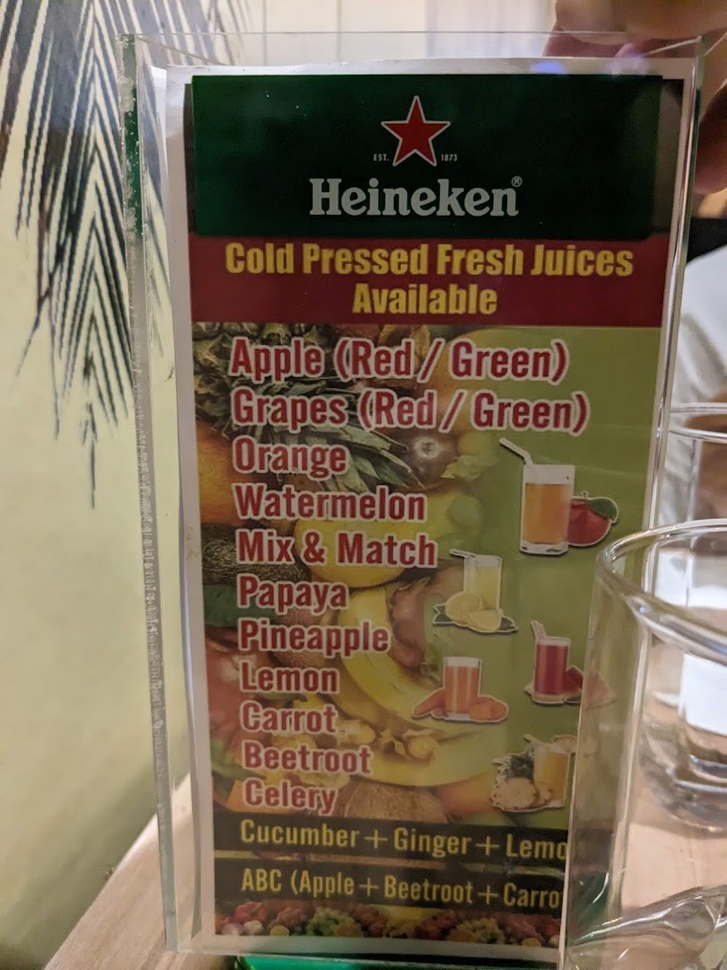 A close-up image of a menu displaying a variety of cold-pressed fresh juices.