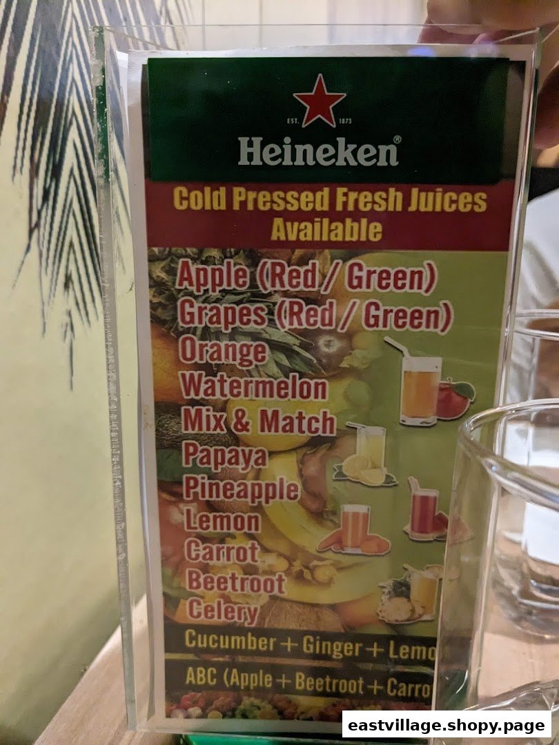 A close-up image of a menu displaying a variety of cold-pressed fresh juices.