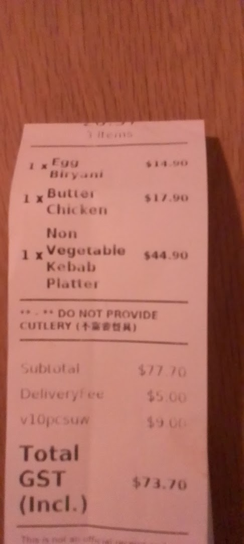 A receipt from Indian Tandoor Restaurant detailing an order of Egg Biryani, Butter Chicken, and Kebab Platter.