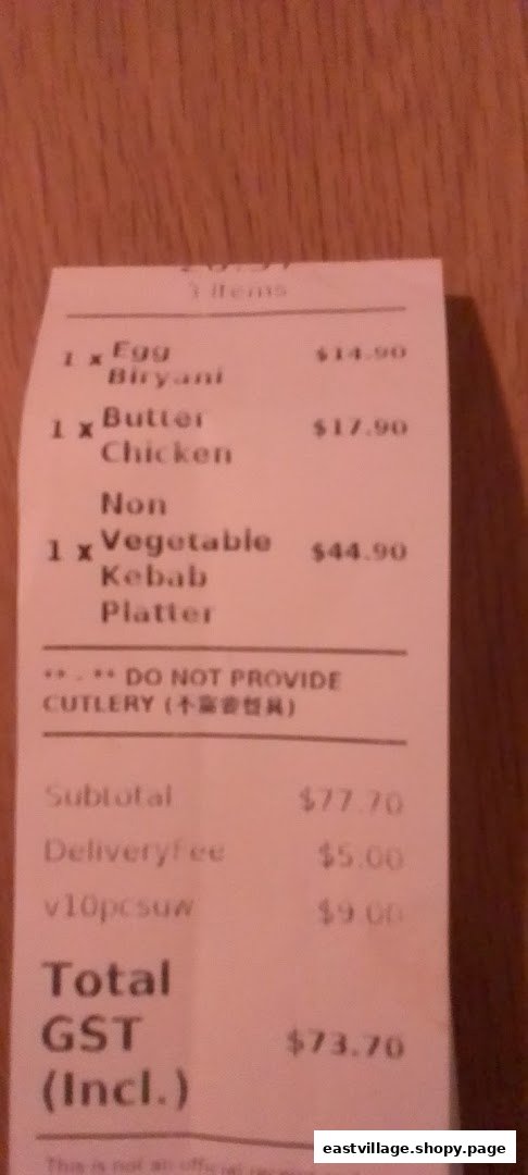 A receipt from Indian Tandoor Restaurant detailing an order of Egg Biryani, Butter Chicken, and Kebab Platter.