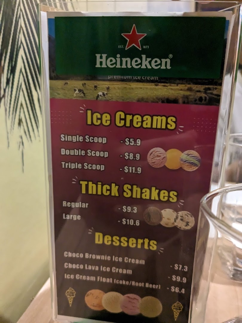 A menu displaying prices for ice creams, thick shakes, and desserts, featuring Heineken premium ice cream.