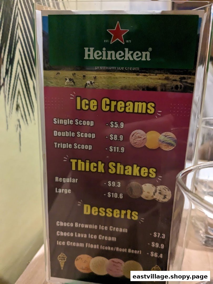 A menu displaying prices for ice creams, thick shakes, and desserts, featuring Heineken premium ice cream.