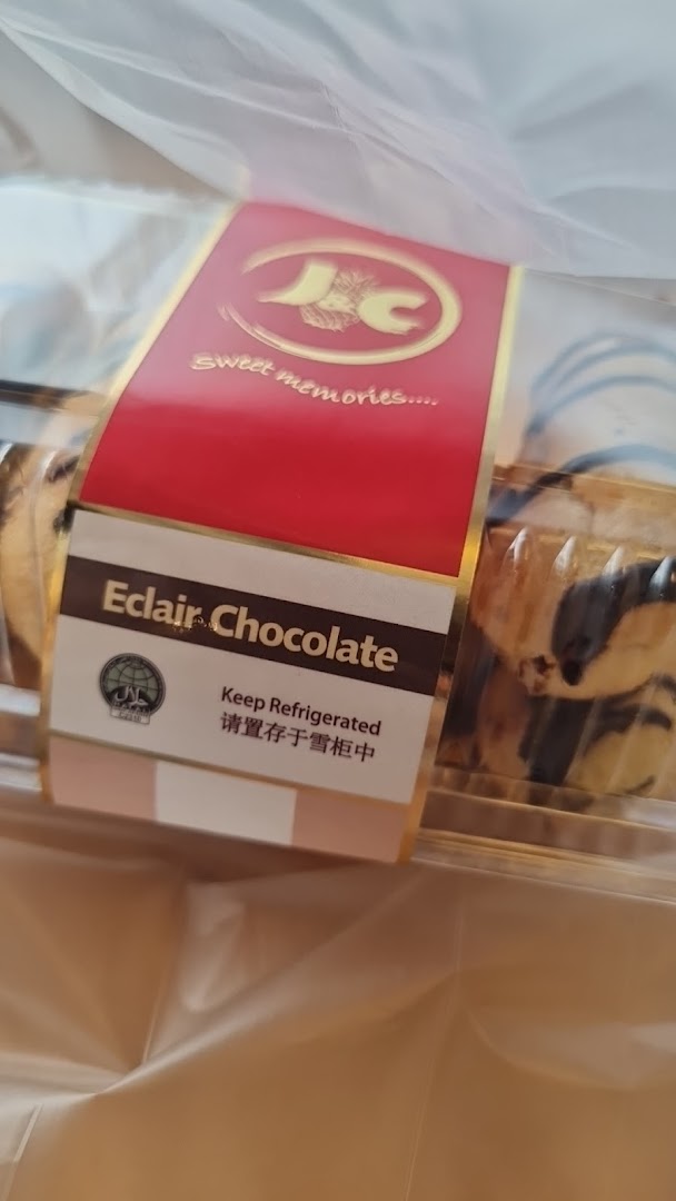 A box of J C Bakery's Eclair Chocolate pastries in a clear plastic bag.