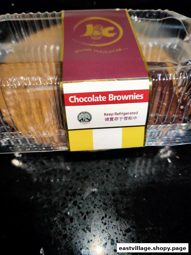 A clear plastic container of J C Bakery chocolate brownies with a branded label.