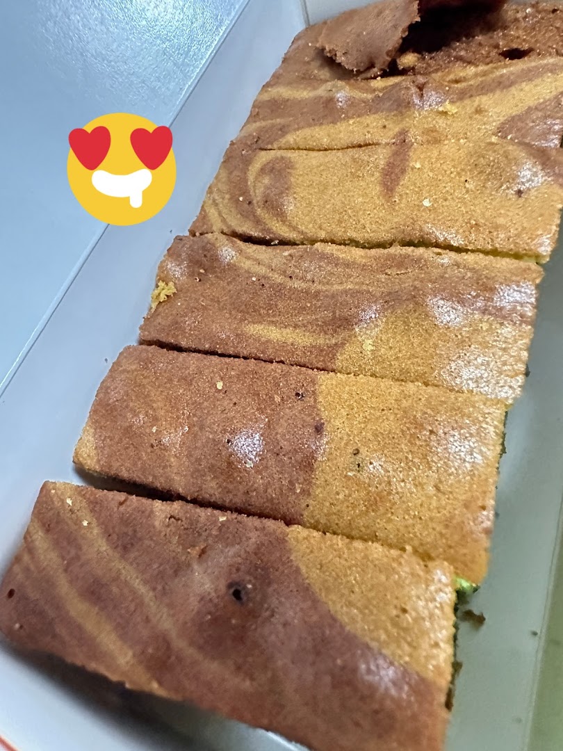 Close-up of delicious marble cake slices with a swirled pattern in a white box.
