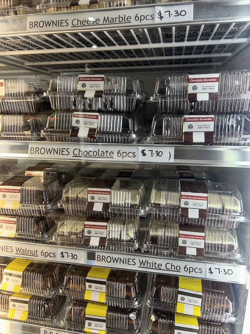 A refrigerated display case filled with various types of brownies in clear plastic containers.