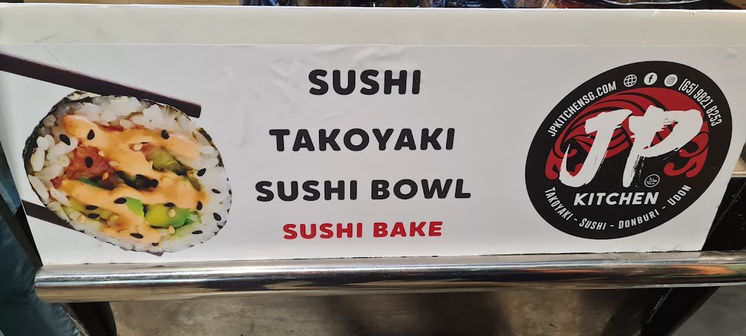 A sign for JP Kitchen displaying popular Japanese food items like sushi, takoyaki, sushi bowls, and sushi bake.