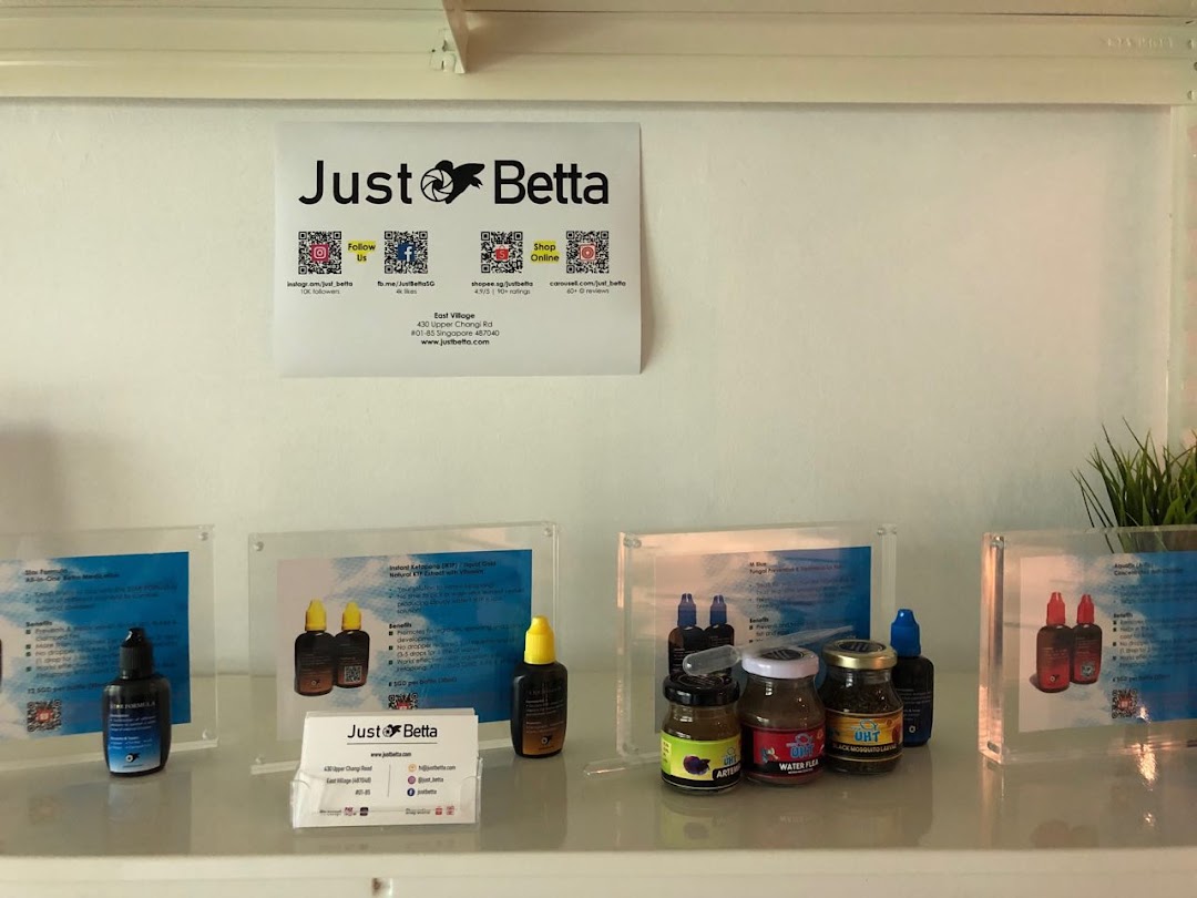 An interior display at Just Betta, showcasing fish care products and branding.