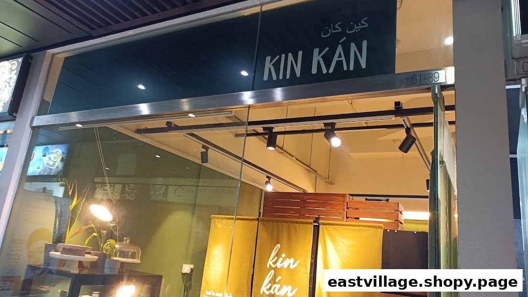 The storefront of Kin Kán, featuring its name and a glimpse of the interior.