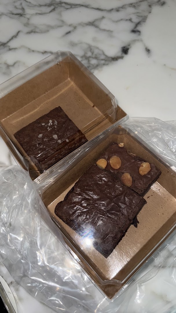 Two boxes of delicious brownies, one with sea salt and one with macadamia nuts.