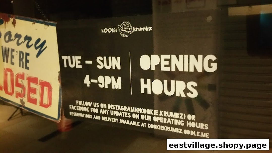 KookieKrumbz shop front displaying opening hours and contact information.