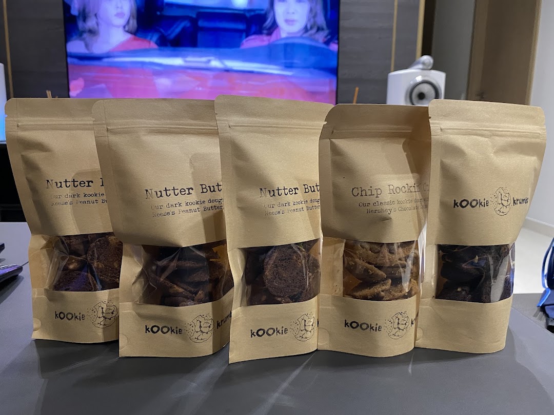 Five stand-up pouches of KookieKrumbz cookies, showcasing delicious flavors like Nutter Butter and Chip Rockin'.