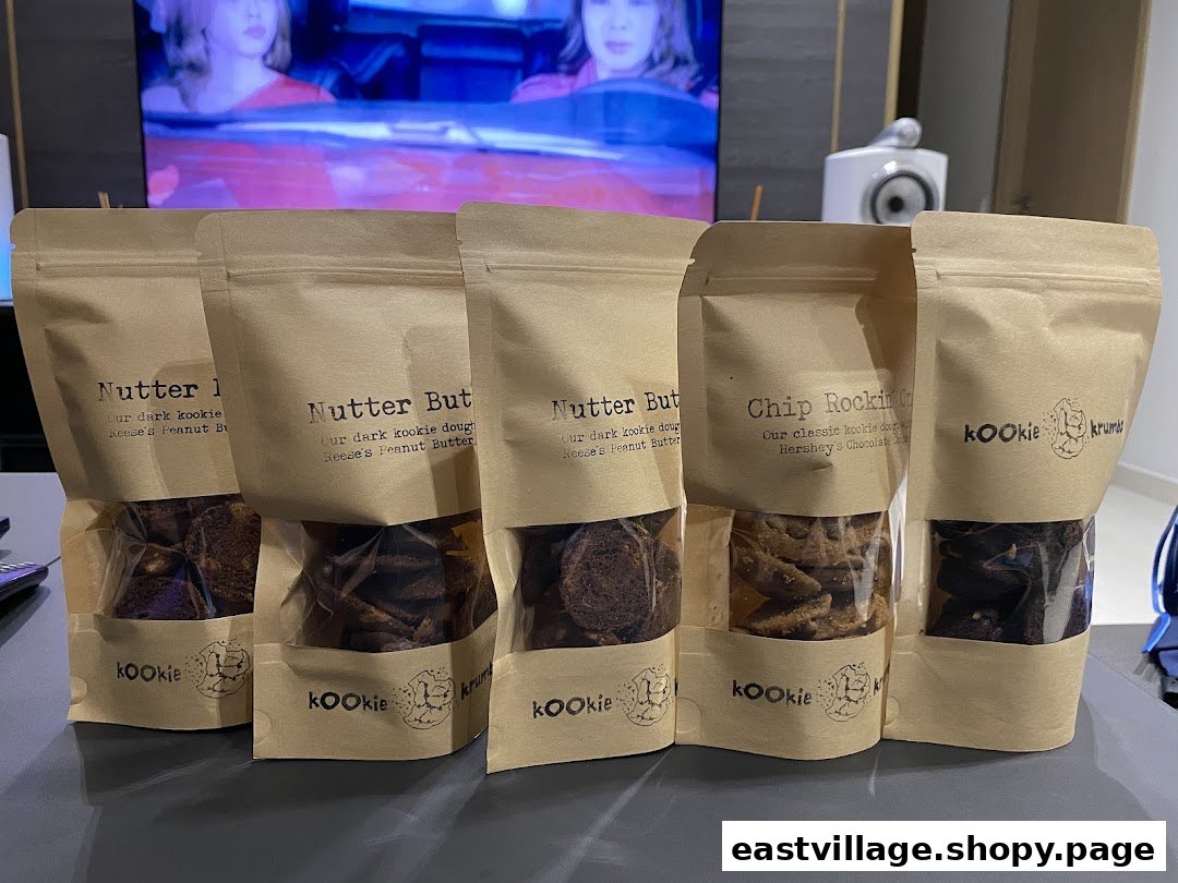Five stand-up pouches of KookieKrumbz cookies, showcasing delicious flavors like Nutter Butter and Chip Rockin'.