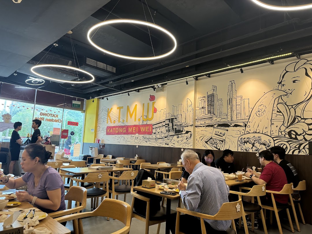Customers enjoy meals inside KTMW Katong Mei Wei chicken rice tea-cafe, featuring unique wall art.