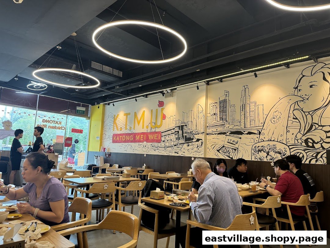 Customers enjoy meals inside KTMW Katong Mei Wei chicken rice tea-cafe, featuring unique wall art.