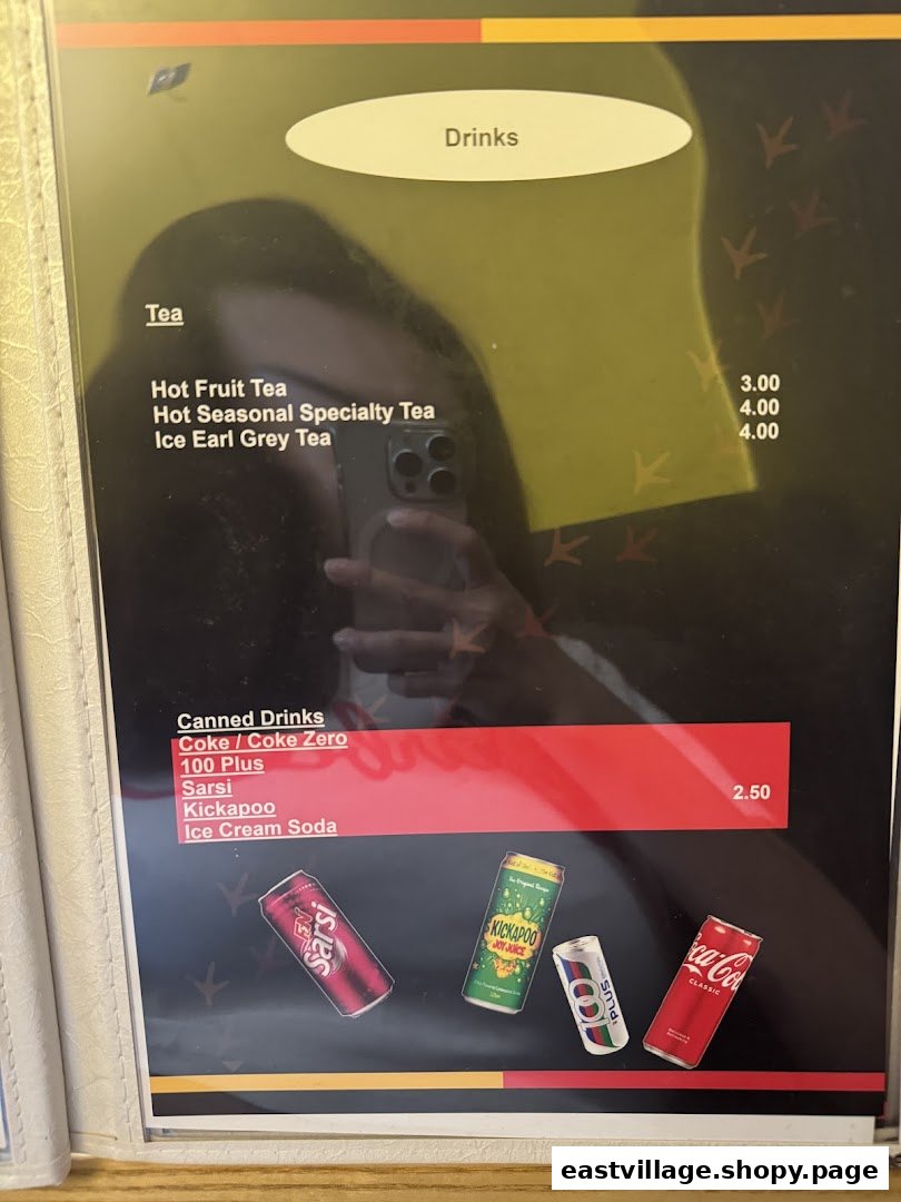 A drinks menu featuring various teas and canned beverages with prices.