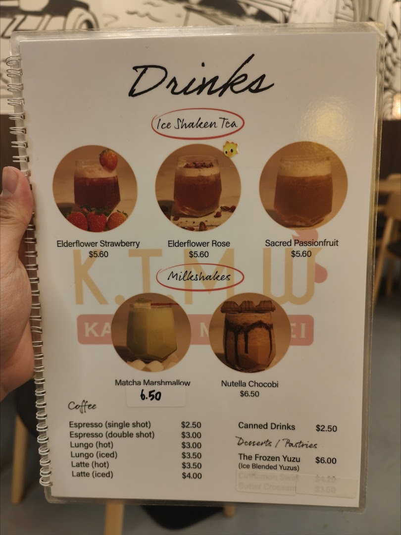 A menu displaying various drinks, including ice shaken teas, milkshakes, coffee, and some desserts.