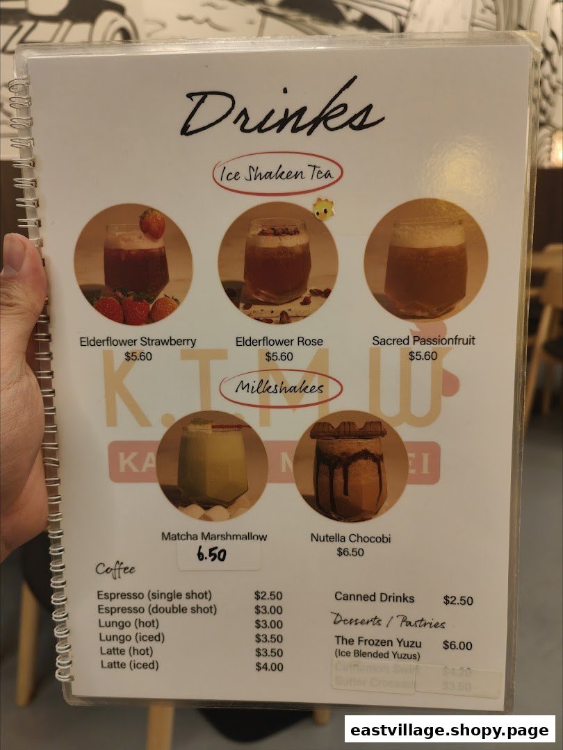 A menu displaying various drinks, including ice shaken teas, milkshakes, coffee, and some desserts.