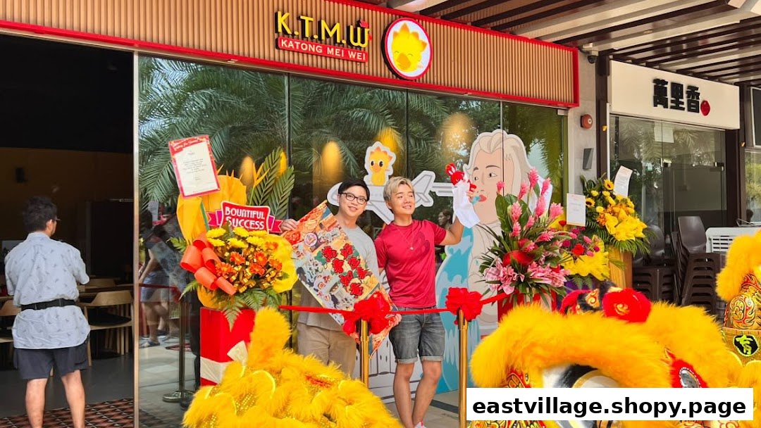 The shop front of KTMW Katong Mei Wei chicken rice tea-cafe, adorned with grand opening decorations and two individuals.