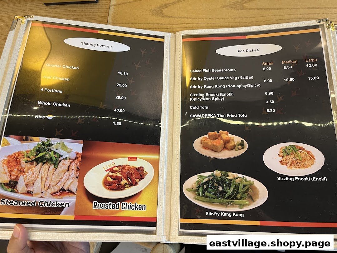 An open menu displaying chicken rice sharing portions, side dishes, and images of steamed and roasted chicken.