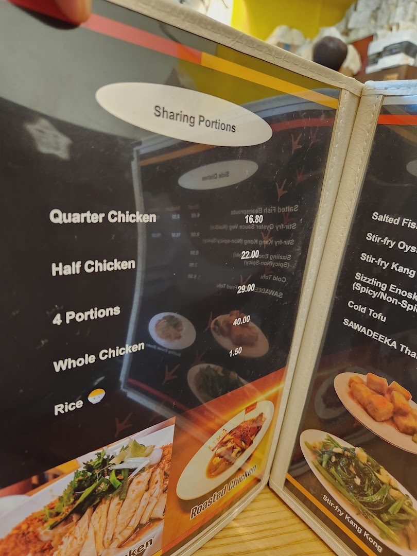 A close-up view of a menu displaying chicken rice and other Thai-inspired dishes.