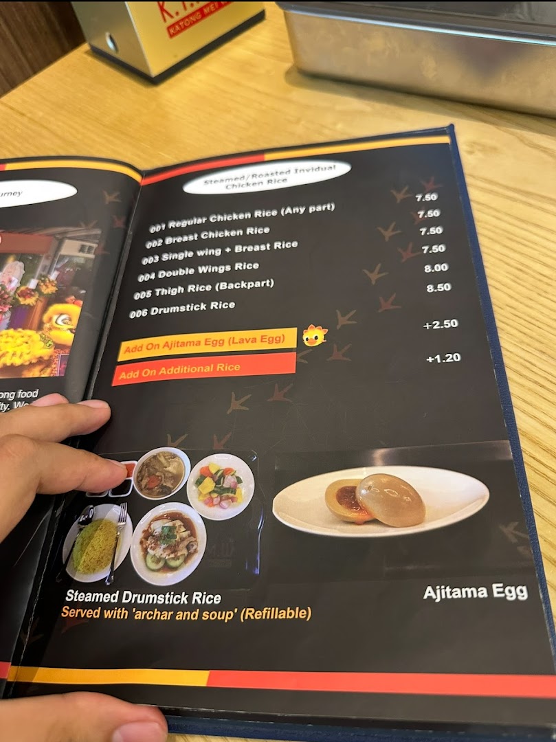 A close-up of a menu page displaying various chicken rice options and add-ons with prices.