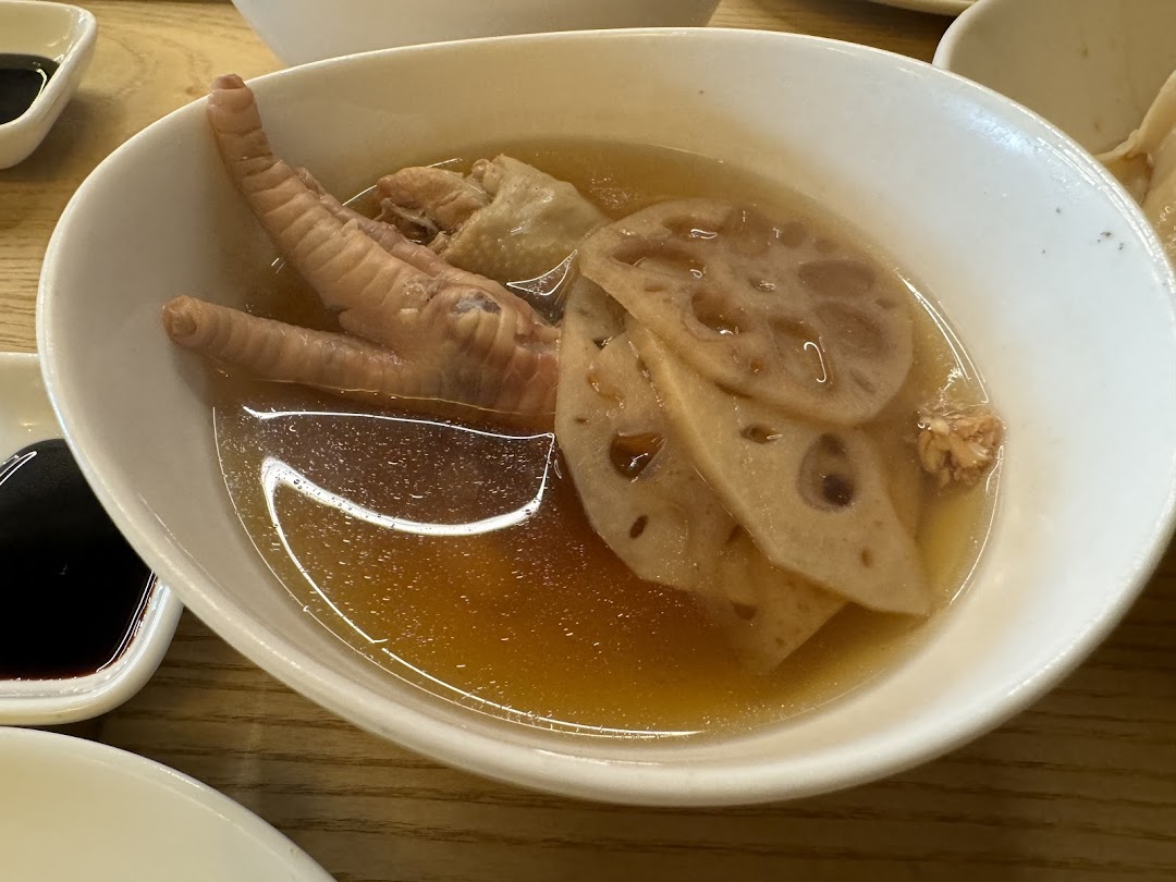 A close-up of a comforting bowl of chicken feet and lotus root soup.