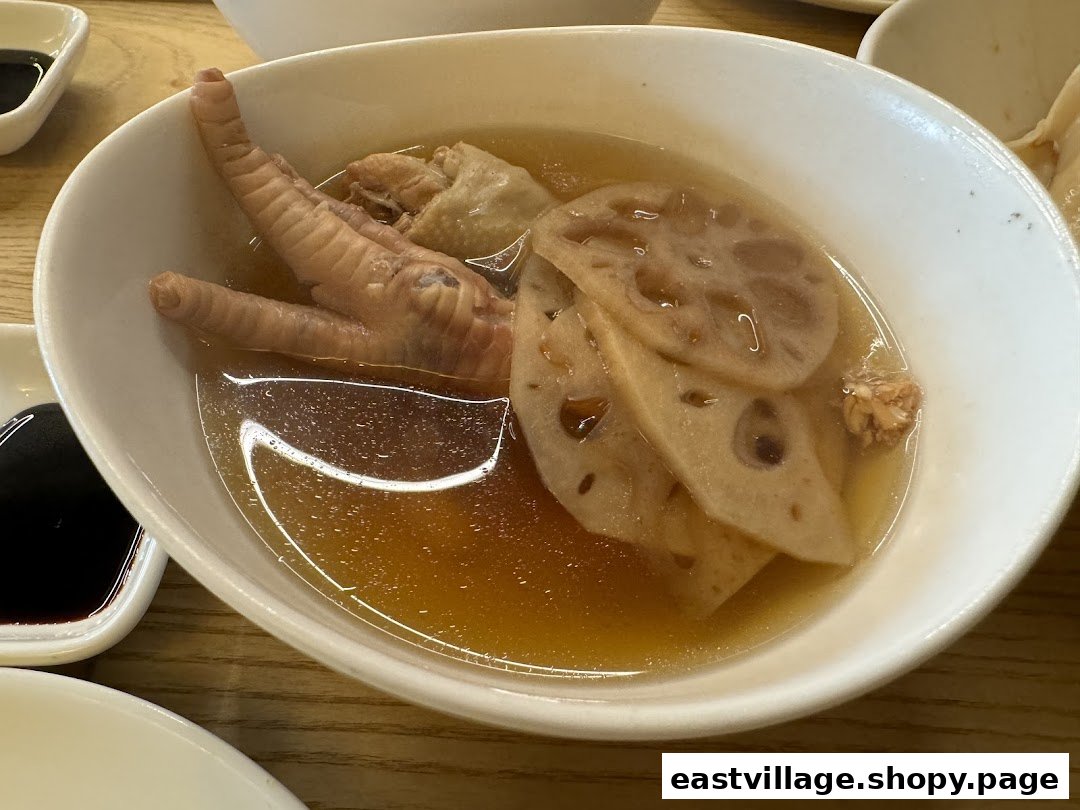 A close-up of a comforting bowl of chicken feet and lotus root soup.