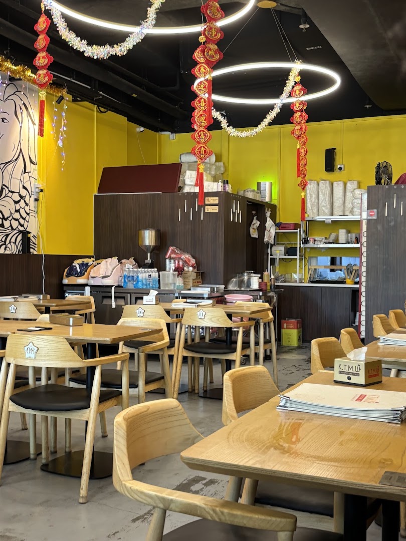 Interior view of KTMW Katong Mei Wei chicken rice tea-cafe with wooden tables and chairs.