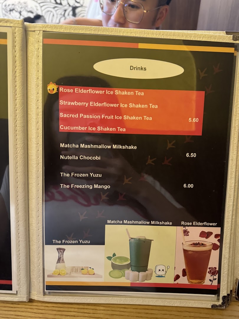 A close-up of a drinks menu from KTMW KATONG MEI WEI, featuring teas, milkshakes, and frozen beverages.