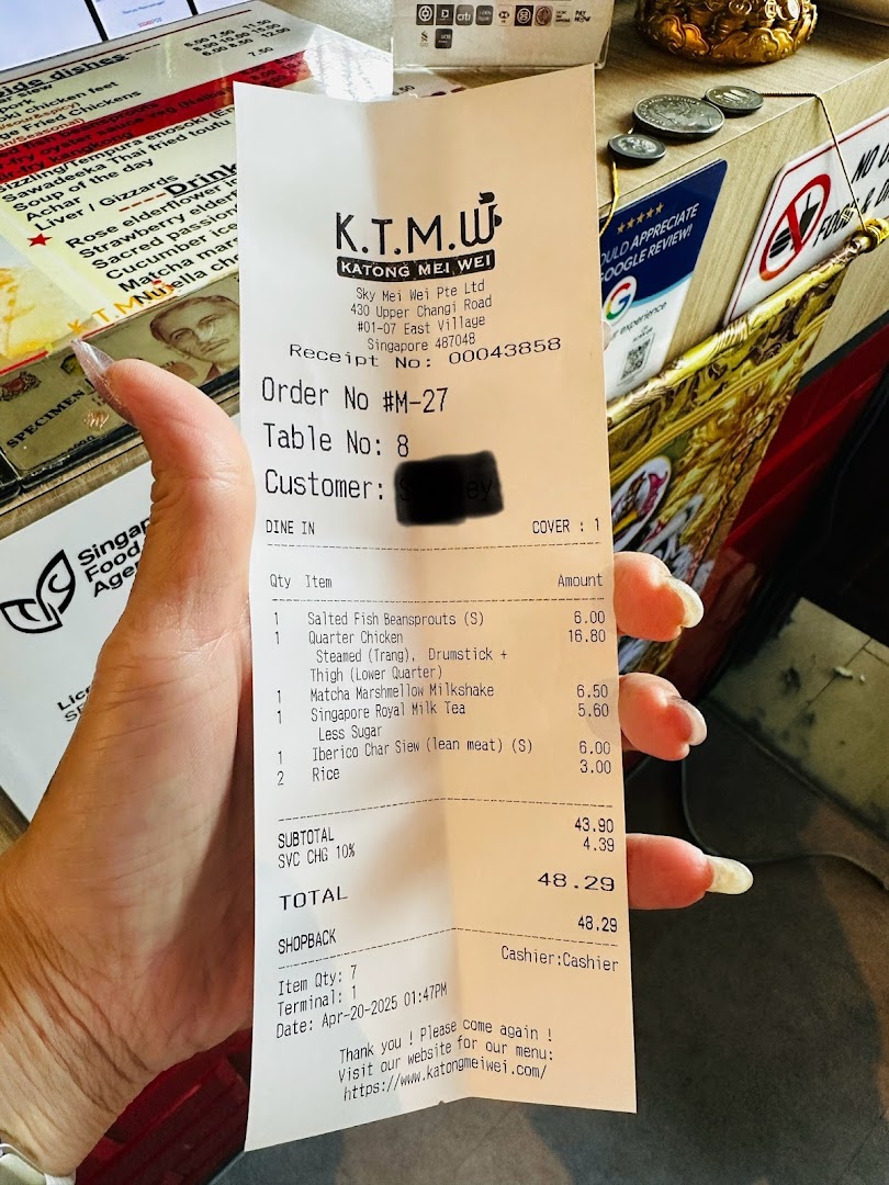 A hand holds a detailed receipt from KTMW Katong Mei Wei, listing various food and drink items with prices.