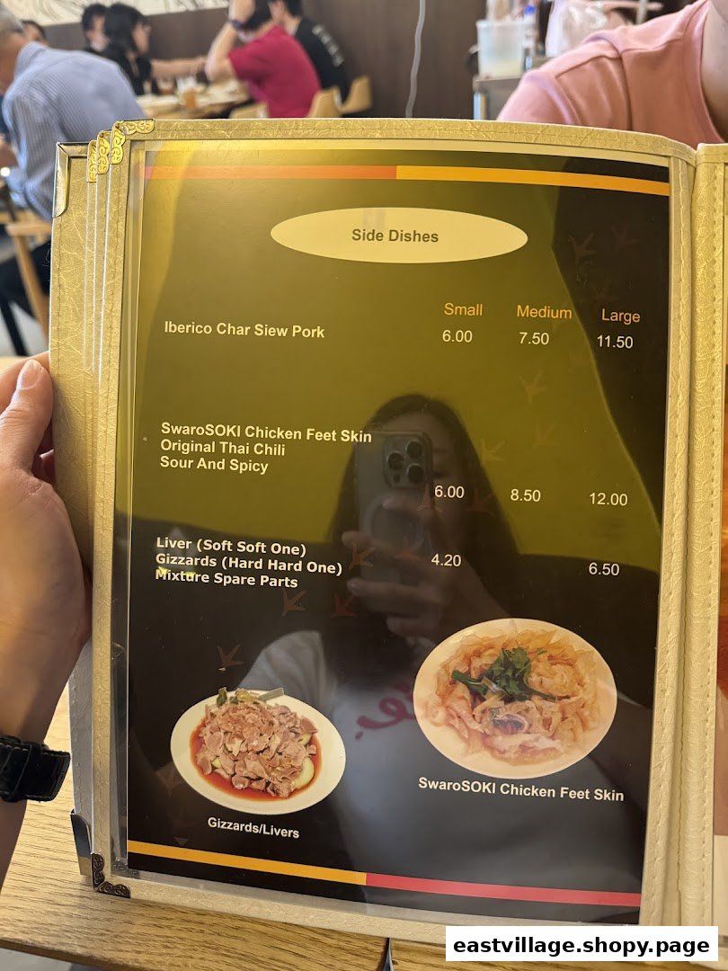 A close-up view of a menu displaying side dishes and their prices at KTMW Katong Mei Wei.