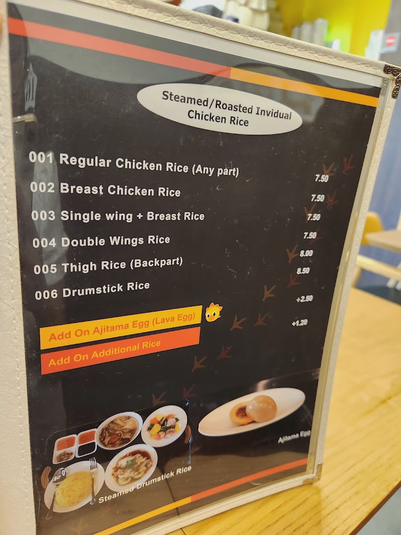 A close-up view of a menu board displaying various chicken rice options and add-ons.