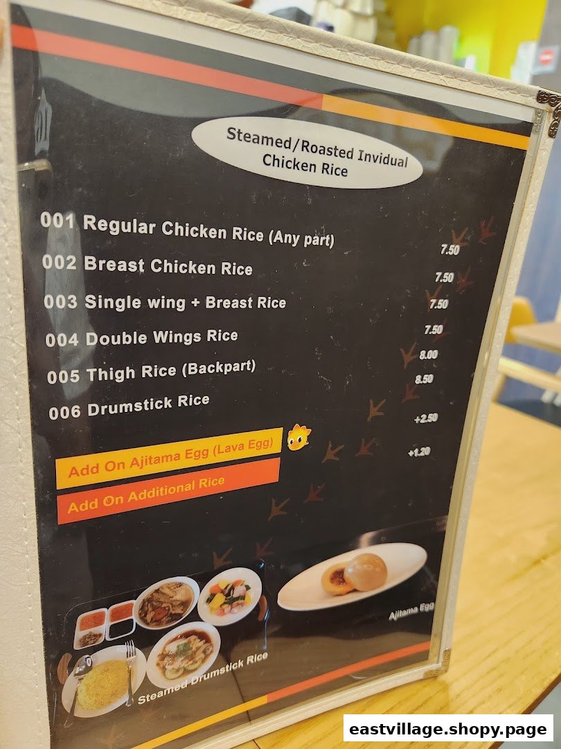 A close-up view of a menu board displaying various chicken rice options and add-ons.